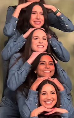 four women are posing for the camera with their hands on their heads