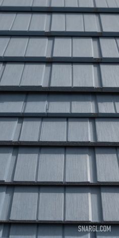 Close up of a roof with a metal shingled roofing system on it's side and a blue sky background. Color #7BADB6. PANTONE, PANTONE 5493. Aesthetic landscapes and cityscapes.Follow us and visit our site for more amazing content! #naturephotography #AI #PANTONE5493 #system #landscape_captures #Close #shingled #landscapephotography #skylovers #aesthetic #travelphotography #nature #graphic #roofing #landscape