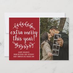 a red christmas card with the words extra merry this year and an image of two people kissing