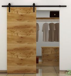 an open sliding door in a bedroom with clothes hanging on the rail and drawers below