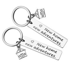 two keychains with the words new home, new home and new adventures written on them