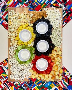 an assortment of fruits and cereals arranged in the shape of a face on a board