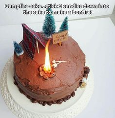 there is a cake that has been decorated with trees and a camp sign on it