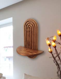 a wooden shelf mounted to the side of a wall next to a vase with flowers