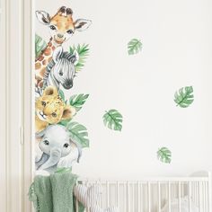 a baby's room with a giraffe, zebra and elephant wall decals