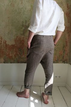 "Linen drop-crotch pants for men are a part of your casual outfit or any specific occasion. A loose cut around the thigh with a narrow shape through the leg feels very comfortable even during the hottest days. The above ankle length of the pants looks good with sandals as well as sneakers. These stylish pleated pants have four pockets - one at each side and two in the back. You will be beloved to wear them! DETAILS: - OEKO-TEX certified product (Sustainable Textile) - Zip fly with two buttons cl Brown Relaxed Fit Straight Leg Harem Pants, Brown Relaxed Fit Harem Pants, Bohemian Bottoms With Relaxed Fit And Tapered Leg, Fitted Linen Bohemian Bottoms, Fitted Bohemian Linen Bottoms, Bohemian Brown Relaxed Fit Bottoms, Linen Pants For Men, Linen Pants Men, Linen Trousers Men