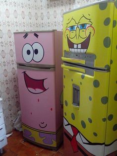 two refrigerators with cartoon characters painted on them in a room next to each other