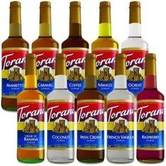 six bottles of torani syrup are lined up