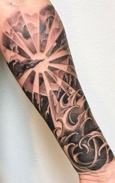 a man's arm with an abstract tattoo design on the left side of his arm