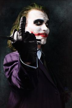 a man dressed as the joker pointing his finger