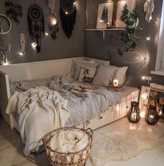 a bedroom with lights strung from the ceiling and decorations on the wall, along with a bed