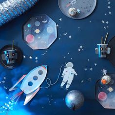 an image of space themed wallpaper with rockets and stars on the surface in blue