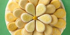 an overhead view of some cookies with yellow flowers on them and white icing in the middle