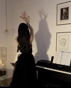 a woman standing in front of a piano