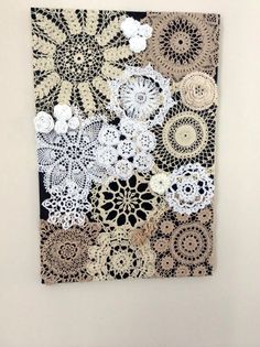 a piece of crocheted doily hanging on a wall