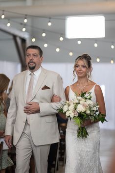 the bride and groom are walking down the aisle