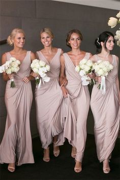 the bridesmaids are all wearing different styles of dresses and holding their bouquets