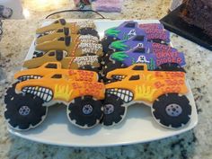 monster trucks decorated cookies on a white plate