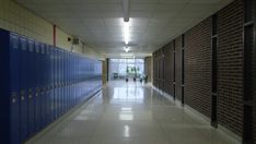 an empty hallway between two rows of lockers