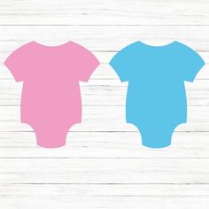 two baby onesuits sitting next to each other on top of a wooden floor