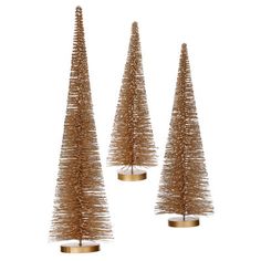 three small christmas trees are shown in gold