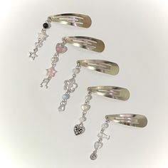 five different types of hair clips with charms on them