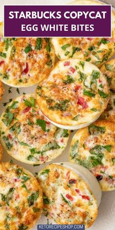 several small pizzas with cheese and spinach on top, sitting on a plate