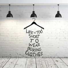 an image of a room with clothes hanging on the wall and words written in black