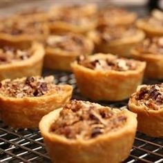 there are many small pies on the cooling rack with words that read pecan lasses