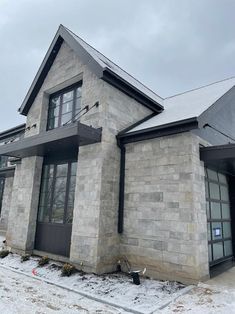 the front of a house with snow on the ground