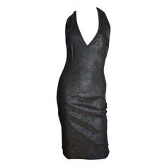 A fabulous laser cut black leather halter dress by Gianni Versace. It has a plunging neckline and low cut back accentuated with 2 fine leather straps crossing it. The leather is intricately laser cut in a pattern of tiny perforations and abstract shapes. The dress is semi fitted with a side invisible zipper and black snaps at the back neck. Fits sizes Small, Extra Small. Bust Open Waist 30-31" Hips 36-37" Length 42" Luxury Halter Neck Dress For Night Out, Luxury Fitted Halter Dress For Party, Luxury Fitted Halter Dress For Evening, Missoni Robe, Leather Halter Dress, Skirt Draping, Leather Halter, Black Silk Dress, Perforated Leather