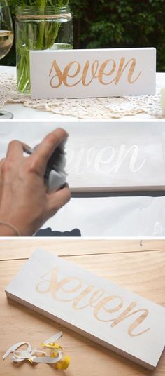 the table is set up for a party with white linens and gold lettering on it