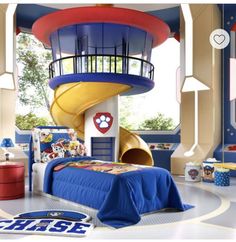 a child's bedroom decorated in blue, red and yellow with a large slide