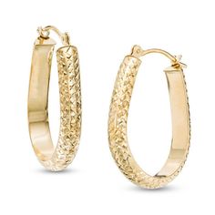 Charm her look with these glittering hoop earrings. Fashioned in warm 14K gold, each 23.0 x 18.0mm "U"-shaped hoop is decorated with shimmering diamond-cut details for a style that's both fresh and surprising. Buffed to a brilliant luster, these fabulous earrings secure with hinged backs. Oval Gold Hoop Earrings With Diamond Cut, Gold Oval Diamond Cut Hoop Earrings, Gold Diamond Cut Oval Hoop Earrings, Gold Hoop Earrings With Diamond Cut, Gold Diamond Cut Hoop Earrings, A Style, Earring Backs, Designer Earrings, Diamond Rings