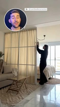 a man standing in front of a living room window