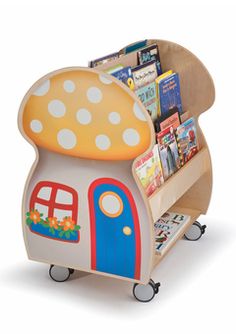 a children's book stand with a mushroom shaped house on the front and wheels