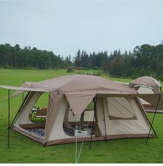 a tent is set up on the grass