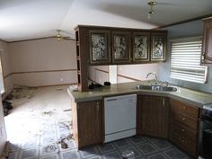 an empty kitchen is shown in the process of remodeling with wood cabinets