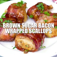 bacon wrapped scallops on a white plate with green garnish and the words brown sugar bacon wrapped scallops