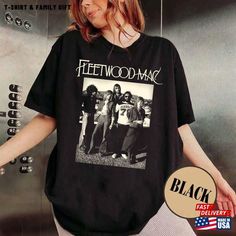 a woman wearing a black t - shirt with an image of the band fleetwood on it