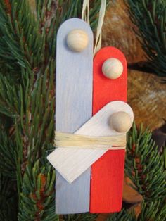 an ornament made out of popsicle sticks and wood is hanging on a christmas tree