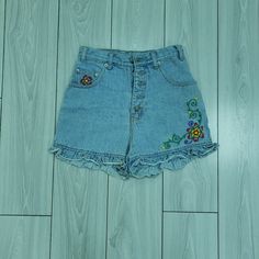 Femme Fatale Vintage 1990s Denim Shorts With Floral Embroidery Retro Embroidered Denim Bottoms, Embroidered Medium Wash Denim Jean Shorts, Vintage Floral Embroidered Bottoms For Summer, Retro Embroidered Bottoms For Spring, Vintage Embroidered Denim Blue Bottoms, Vintage Embroidered Summer Bottoms, Embroidered Medium Wash Cotton Jean Shorts, Embroidered Cotton Jean Shorts In Medium Wash, Vintage Embroidered Denim Bottoms