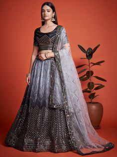 Elevate your ethnic wardrobe with our astonishing black sequins chinon reception wear lehenga choli. This stunning ensemble features a black color chinon material lehenga with intricate zig zag sequin work, paired with a matching choli and a grey net dupatta also adorned with sequin work. The black lehenga is semi-stitched up to 42 inches with a 3-meter flair, allowing for a comfortable and flattering fit. The un-stitched choli material and 2.5-meter-long dupatta complete the look, making it per Black Bridal Lehenga, Lehenga For Bridal, Grey Lehenga, Black Lehenga, Party Wear Lehenga Choli, Wedding Party Wear, Bollywood Lehenga, Lengha Choli, Lehenga Style