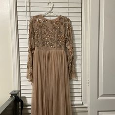 Straight From Boohoo! A Brand New Dress! Only Worn Once! Has Been Ironed(No Wrinkles)! Looks Super Cute! A Beige/Pinkish Color With Some Rose Gold Designs On The Top Area! Beige Long Sleeve Maxi Dress For Party, Festive Long Sleeve Beige Dress, Beige Long Sleeve Embellished Dress, Long Sleeve Embellished Beige Dresses, No Wrinkles, Boohoo Dresses, Beige Dress, Gold Designs, Beige Dresses