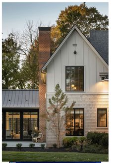 a white house with black windows in the evening