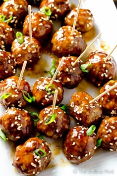 meatballs with sesame seeds and garnish on skewers ready to be eaten