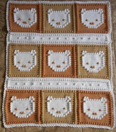 a crocheted blanket with teddy bears and hearts on the squares in different colors