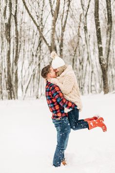 a man and woman kissing in the snow