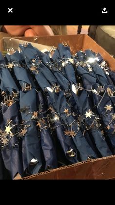 a box full of blue napkins with gold stars on them