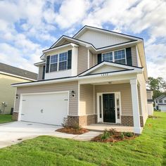 a two story house with white trim and black shutters on the front door is shown